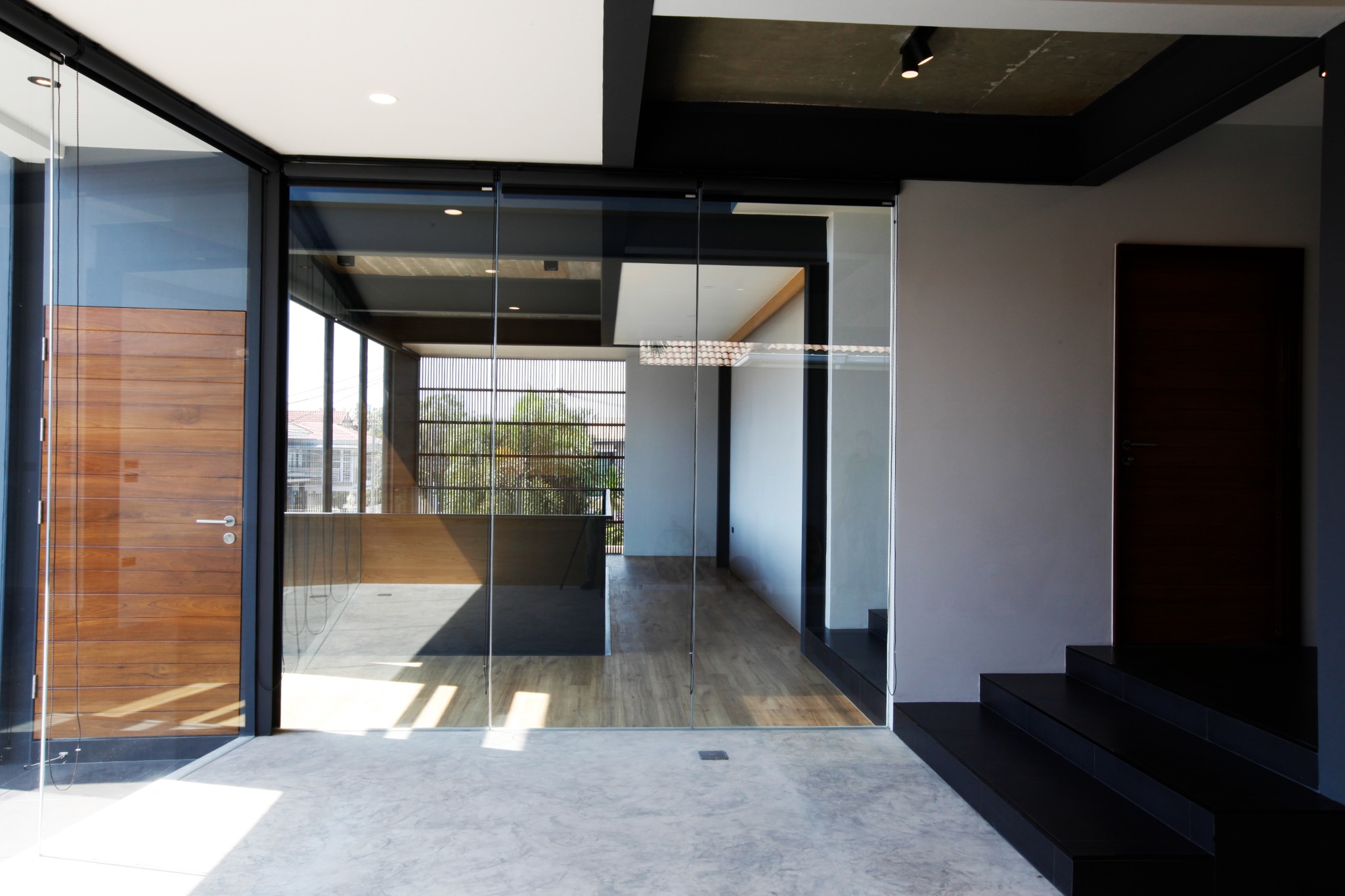 Glazed landing with a timber door and black stair
