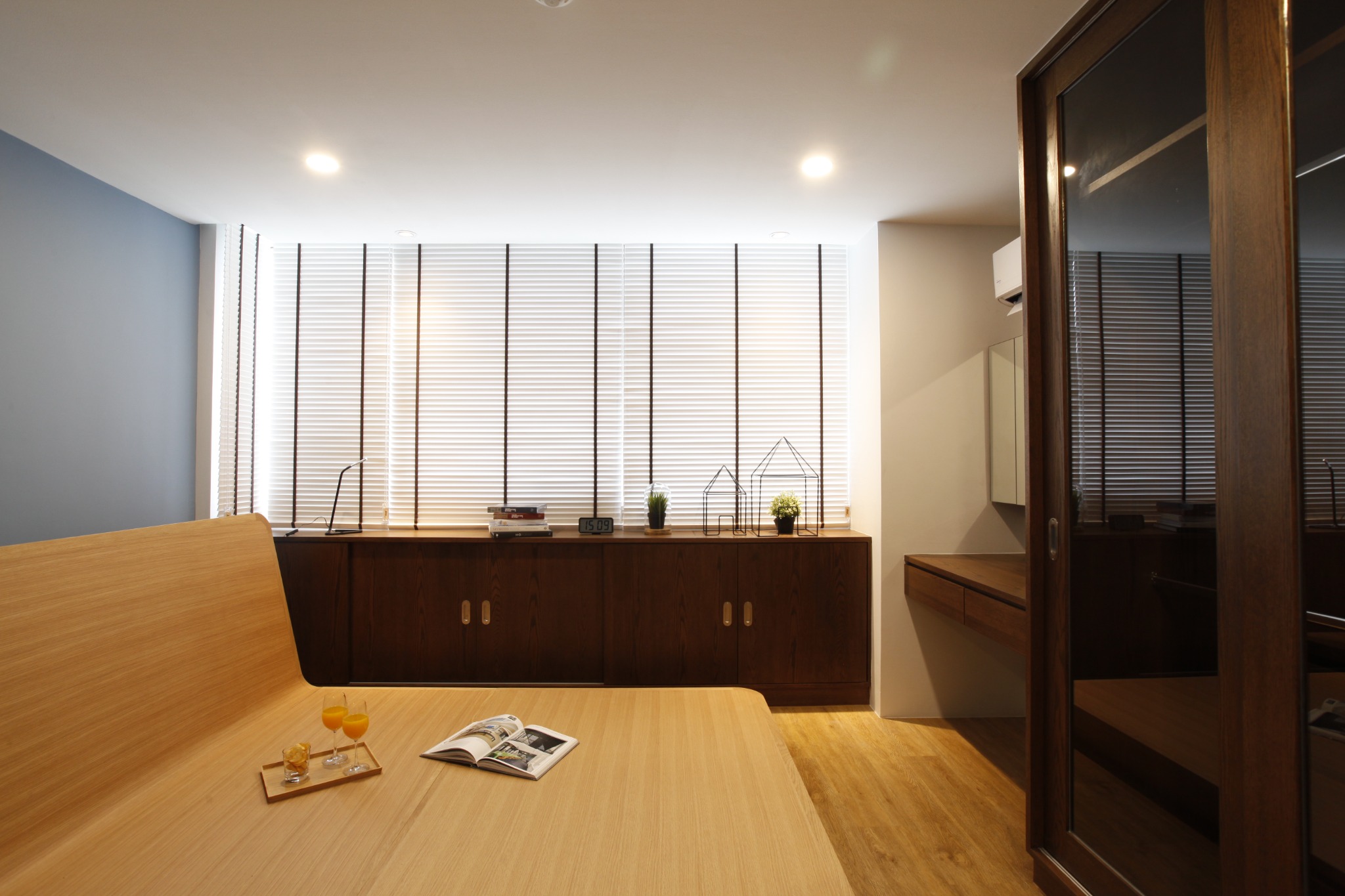 Bedroom with timber bed, built-in storage and screened window